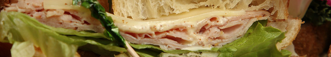 Eating Deli Sandwich at Soma-Dis Deli restaurant in Glasgow, MT.